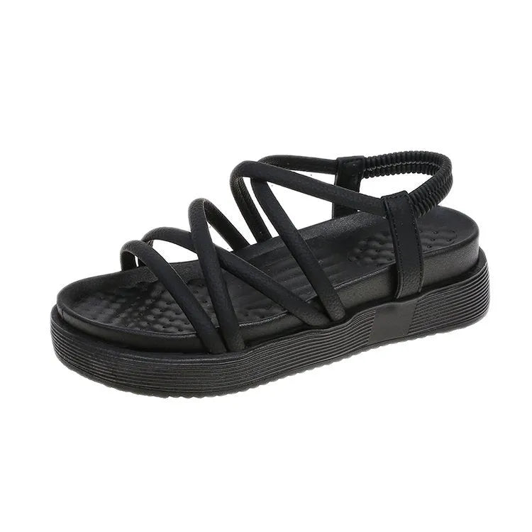 Women's black Roman platform sandals with straps on a white background.