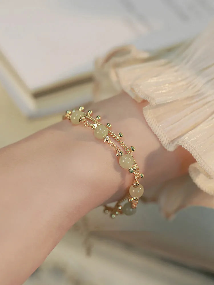 Handmade natural Hetian Jade women's bracelet in a classic beaded style.