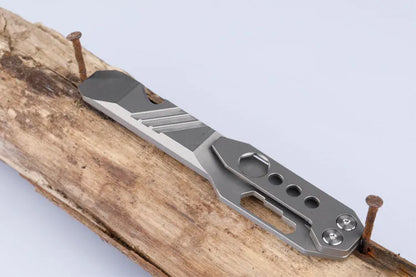 Titanium alloy multi-function crowbar tool with bottle opener on a stone wash finish background.