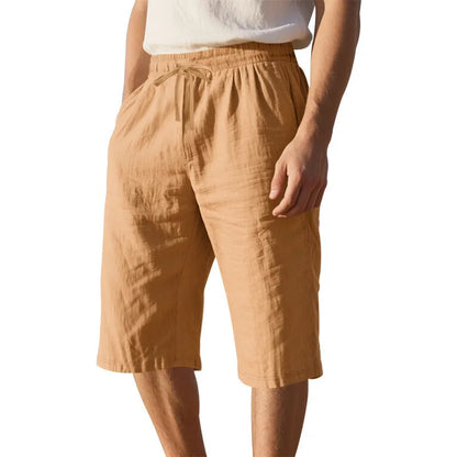 Men's loose-fit linen shorts in a solid colour with a drawstring waist and cropped leg length.