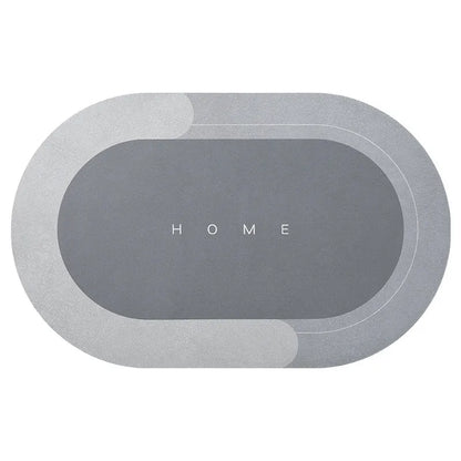 Oval diatomite bathroom floor mat in blue with natural rubber non-slip backing on tiled floor.