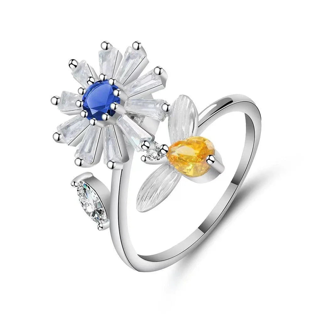 Adjustable spinner ring with rotating floral, geometric, and nature-inspired motifs for women's fashion and stress relief