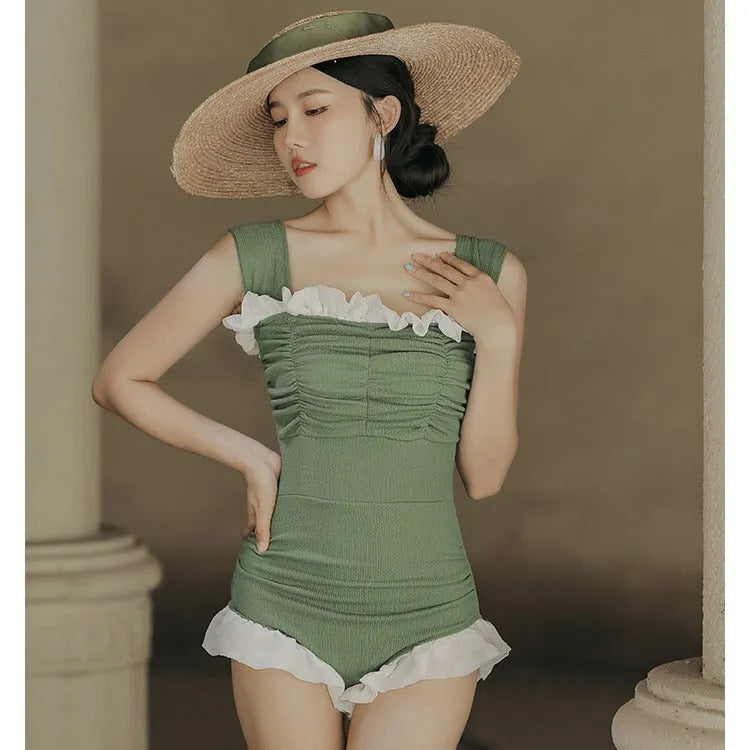 Women's black high-waisted one-piece swimsuit made from quick-drying polyester fabric.