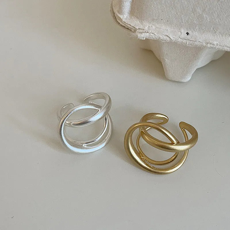 Three-dimensional interlaced geometric open ring in matte metal with real gold plating
