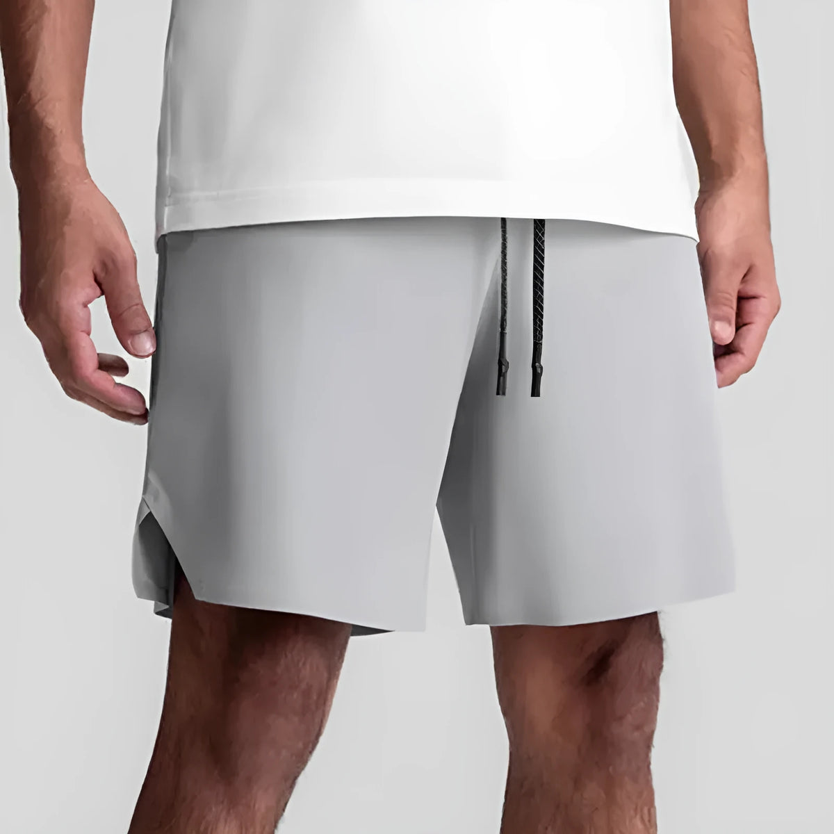 Men's seamless grey sports shorts in straight leg, knee-length quick-dry polyester design.
