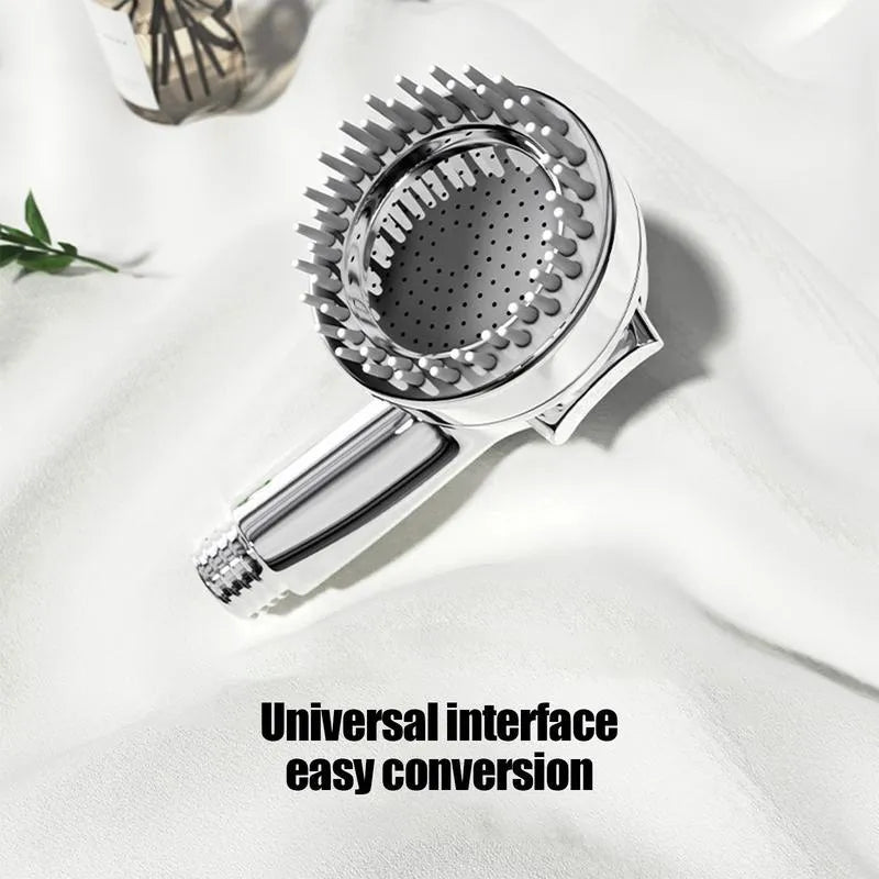 Silver dog shower attachment with integrated silicone comb and rubber grip handles.
