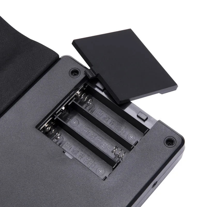 49-key portable folding electronic keyboard in gloss black, showing hand-roll design and compact 28cm size