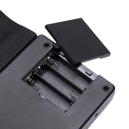 49-key portable folding electronic keyboard in gloss black, showing hand-roll design and compact 28cm size