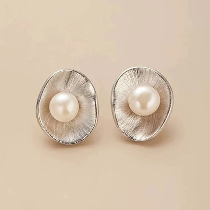 Silver geometric needle earrings with pearl decorative elements on female model