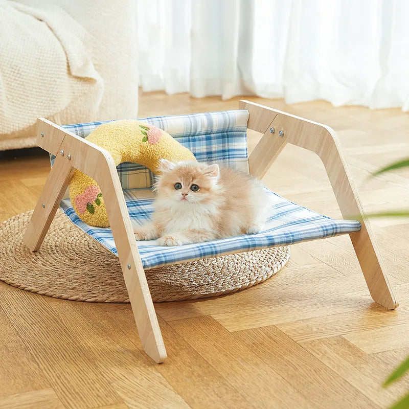 Elevated wooden cat beach chair bed with cloth lounging surface in blue or green.