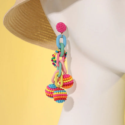 Handmade bohemian shell tassel earrings for women with colourful flower and geometric drop design