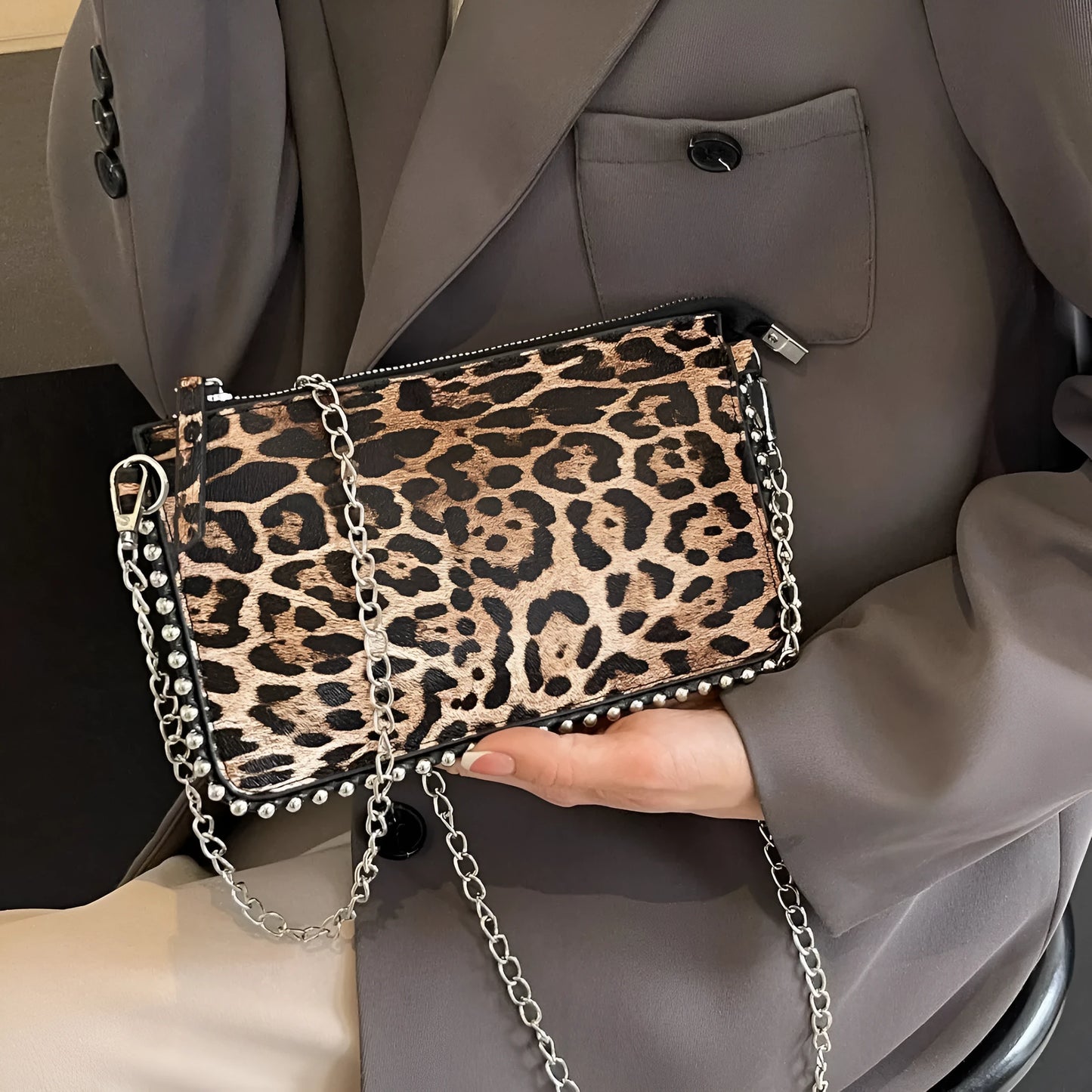 Western style women's brown crossbody bag with chain strap and horizontal square silhouette