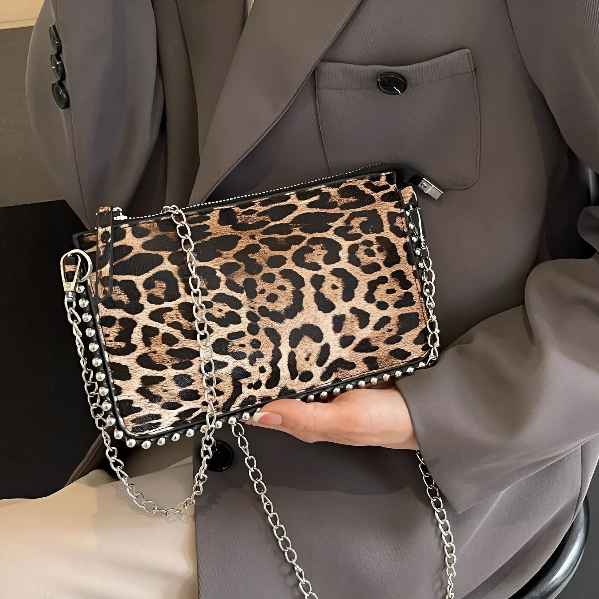 Western style women's brown crossbody bag with chain strap and horizontal square silhouette