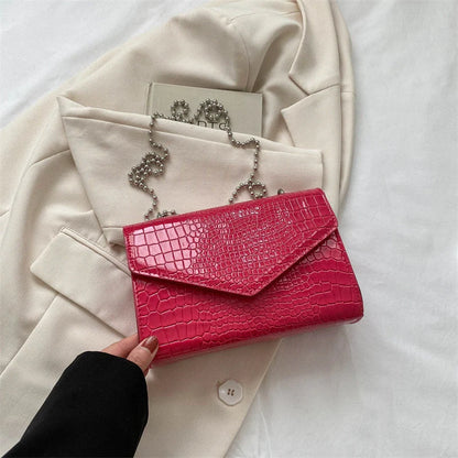 Clamshell handbag with crocodile pattern and soft handle in various colours