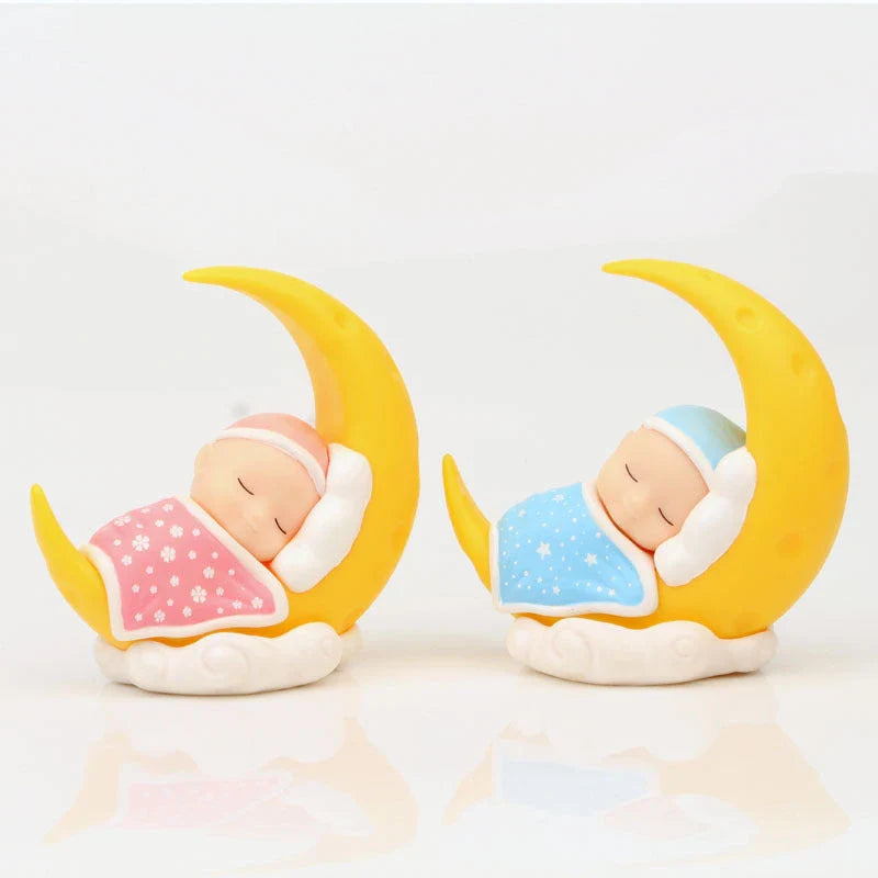 Adorable moon-themed cake decorations and party supplies for baby birthday celebrations