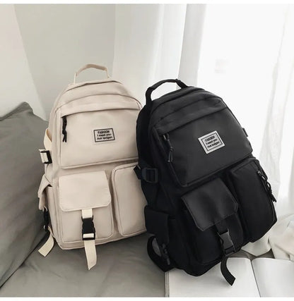 Black and white nylon student backpack with laptop compartment and three-dimensional pocket.