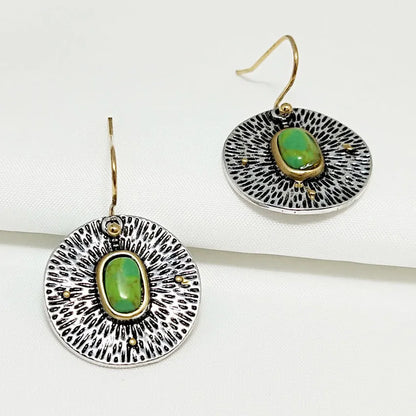 A pair of retro-style earrings with turquoise colour separation and an antique silver electroplated finish.