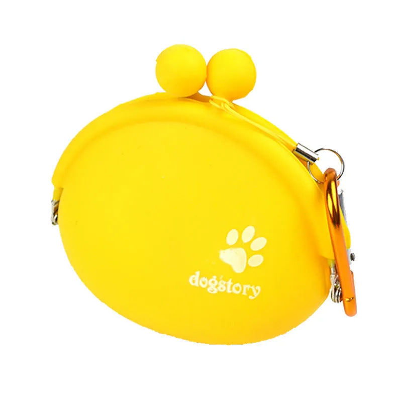 Yellow silicone dog training treat pouch with hook and loop closure, shown on a waistband.