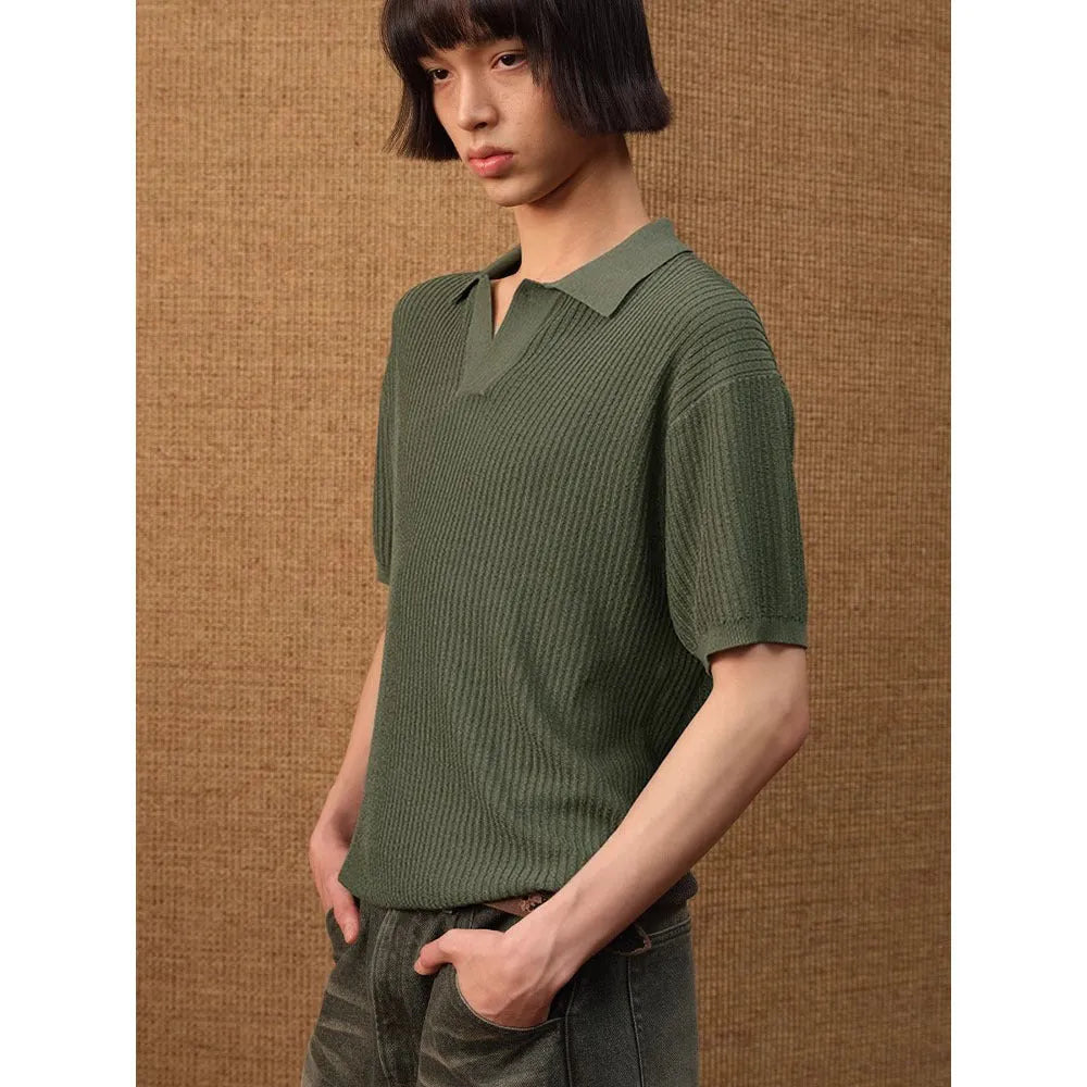 Short sleeve men's polo shirt in grey with striped collar, shown on a hanger.