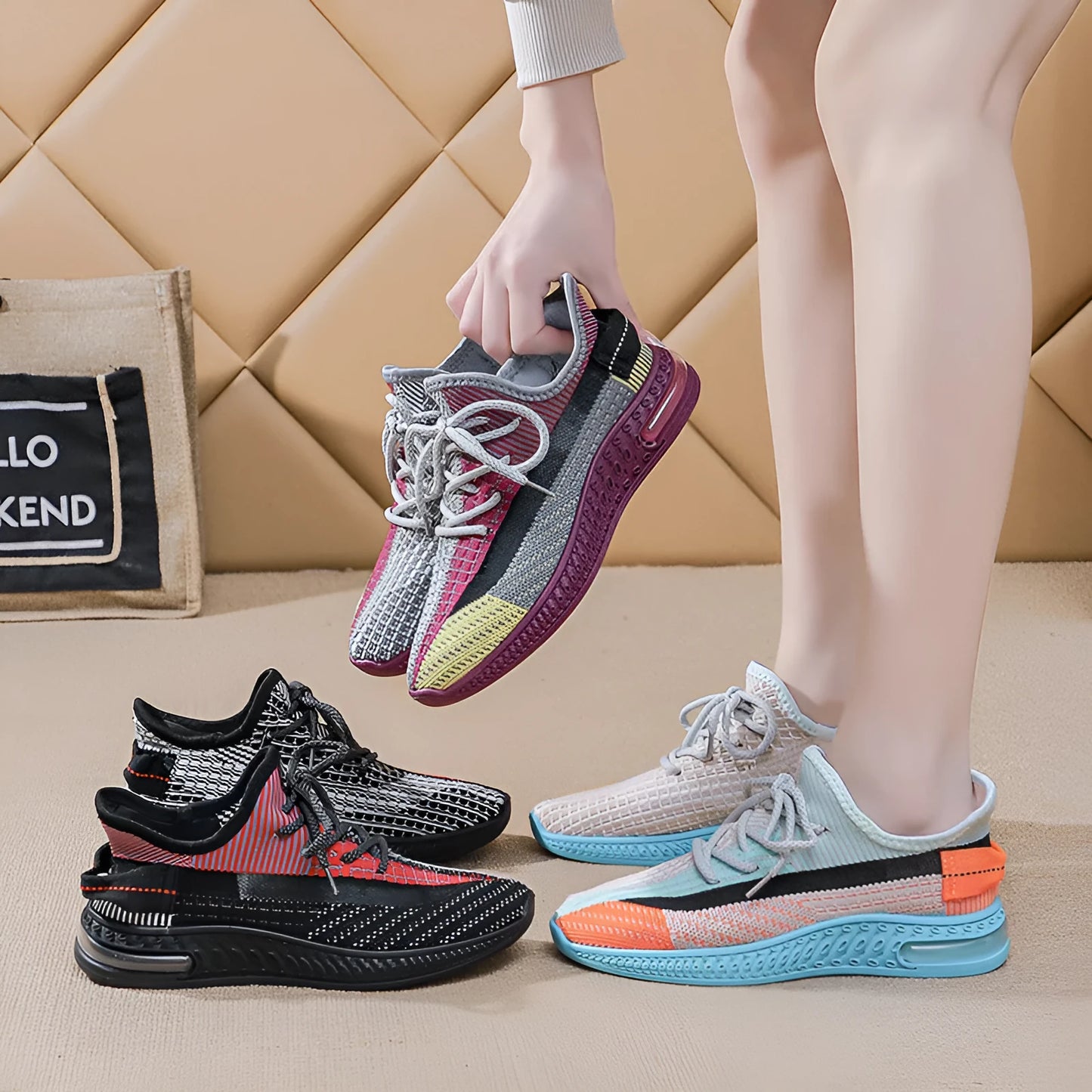 Women's casual running shoes in purple, black, and orange colours with fabric lining and plastic sole