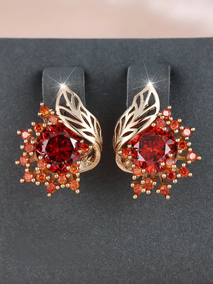 Rose gold plated women's stud earrings with a round flower shape, feather detail, and a central cubic zirconia stone.