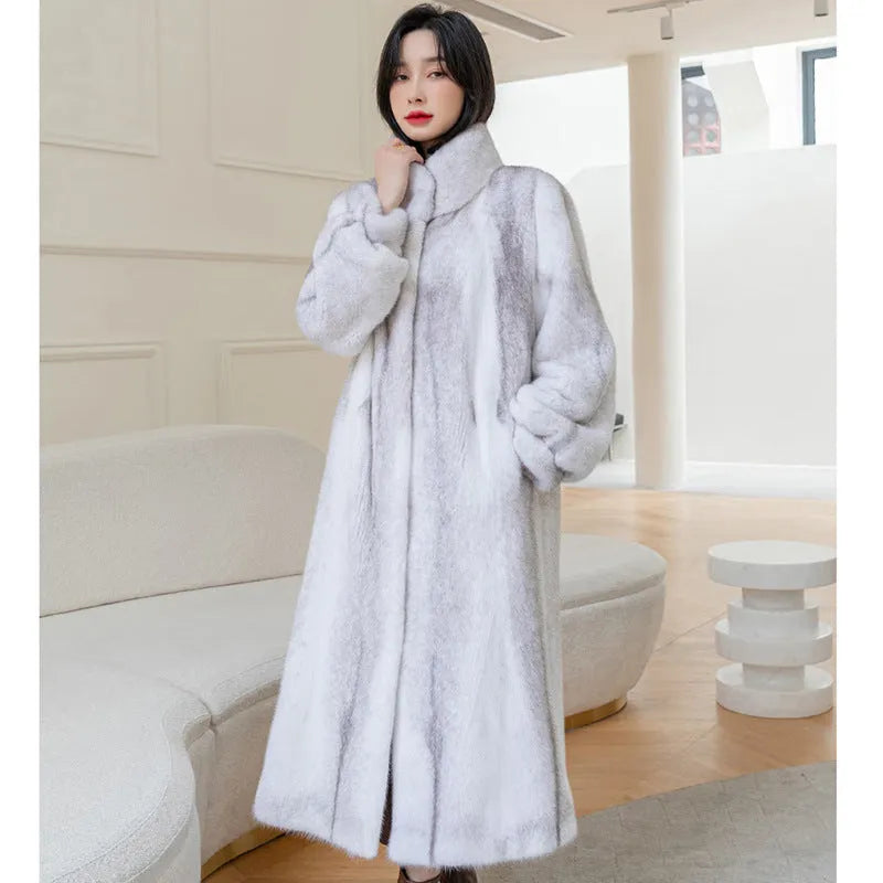 White faux fur women's winter coat with stand-up collar on a hanger