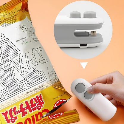 Handheld white portable heat sealer with USB Type-C port and magnetic back on a metal surface.