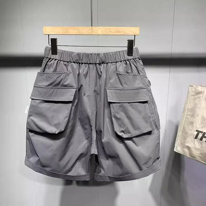 Men's black loose-fit work shorts with multiple pockets showing mid-waist design