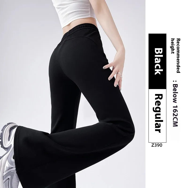 Women's high waist bootcut sports pants in black cotton with fleece lining and micro elasticity, slightly flared leg.
