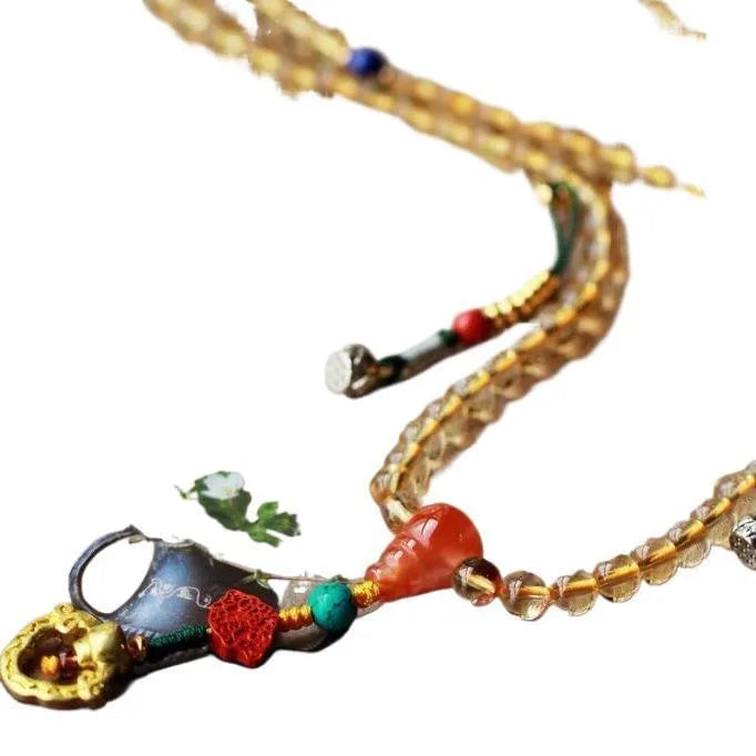 Yellow natural Brazilian citrine bracelet with 1mm beads on a gold-tone filament string.