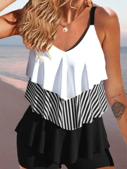 Women's backless sleeveless bikini swimsuit with ruffles and spaghetti straps in a floral pattern.