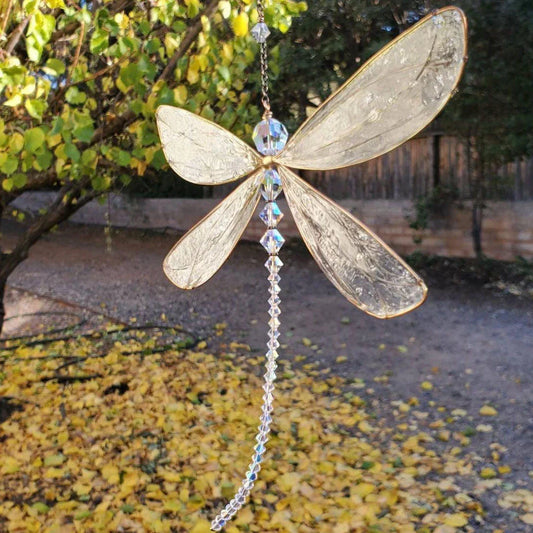 Elegant dragonfly-shaped crystal suncatcher with vibrant rainbow reflections