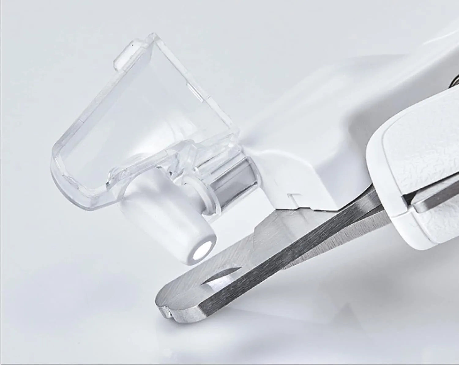 White LED pet nail clippers with a transparent safety guard and a nail file on a grey background.