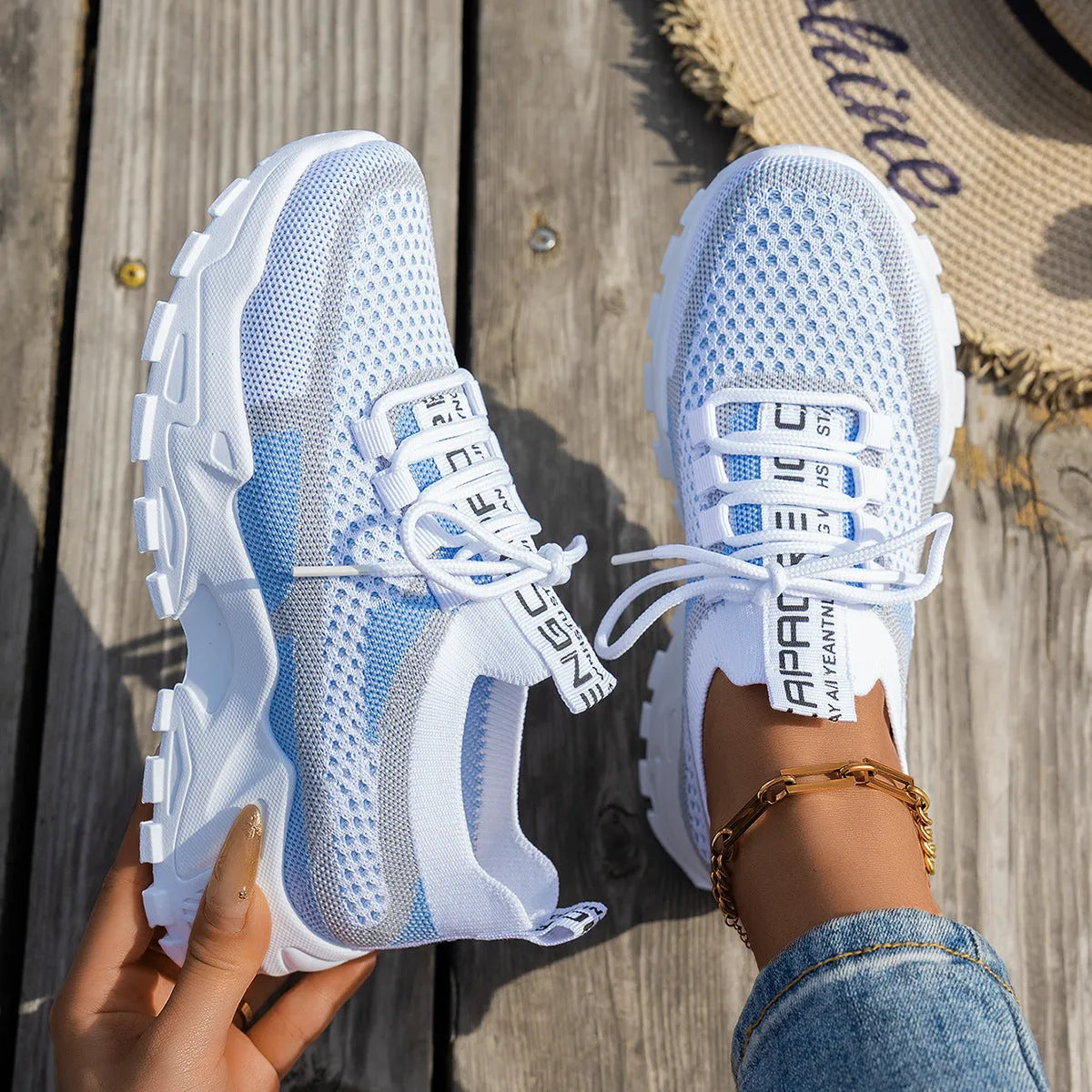 Women's Flyknit mesh lace-up sneaker in a grey colourway showing round toe and rubber sole.