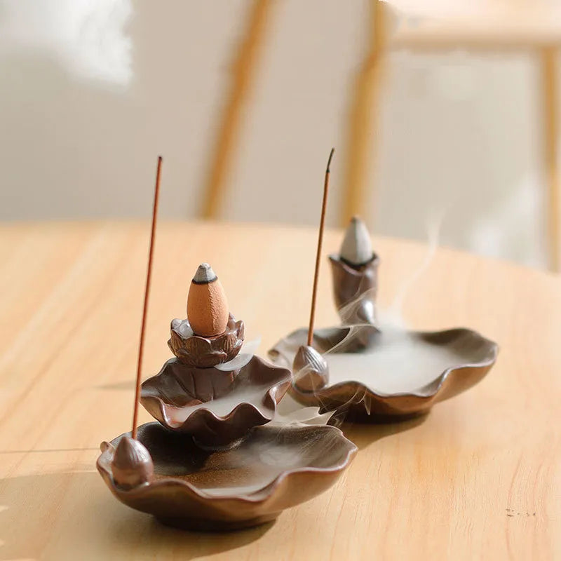 Square ceramic incense burner with reverse flow design showing smoke cascading down sides, Ge kiln crackle glaze patterns visible