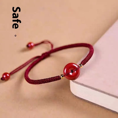 Cinnabar heart-shaped bracelet with safety buckle closure and adjustable coloured rope in traditional Chinese design
