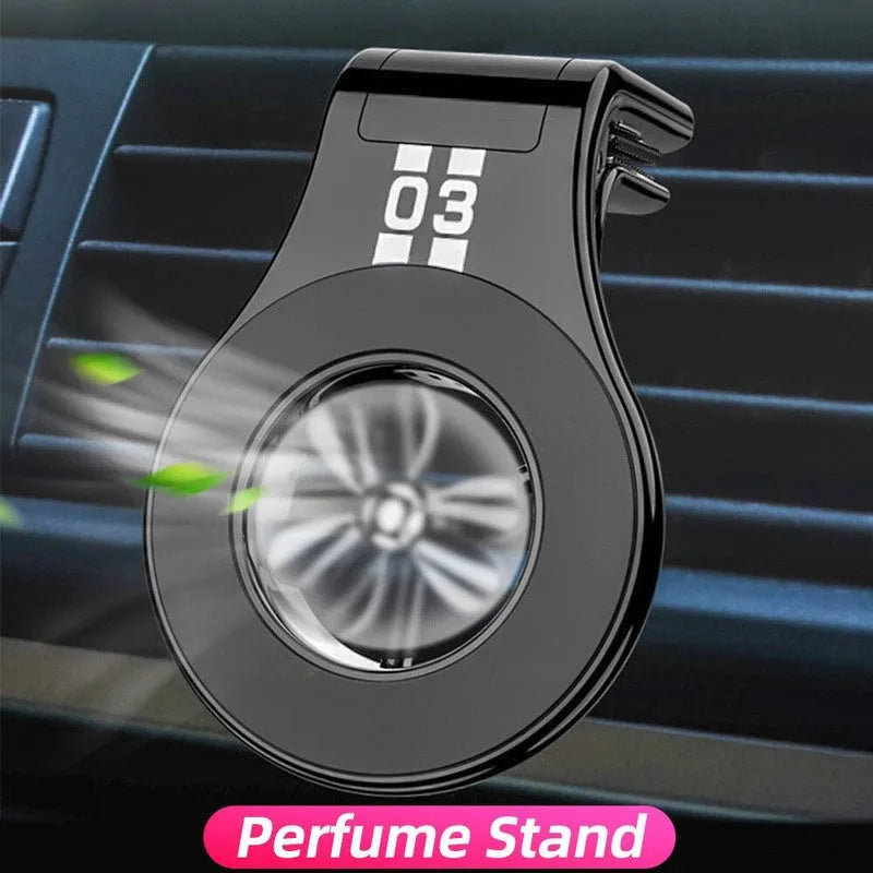 Black magnetic car phone holder attached to air vent with phone mounted and fragrance slice visible