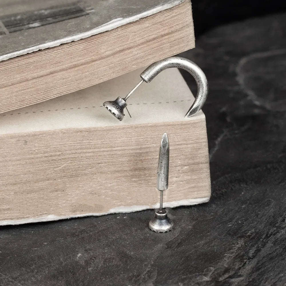 Sterling silver nail stud earrings showing straight and curved punk retro styles