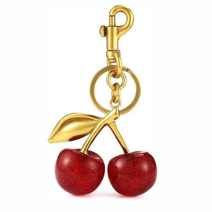Red zinc alloy cherry-shaped keychain pendant on a key ring.