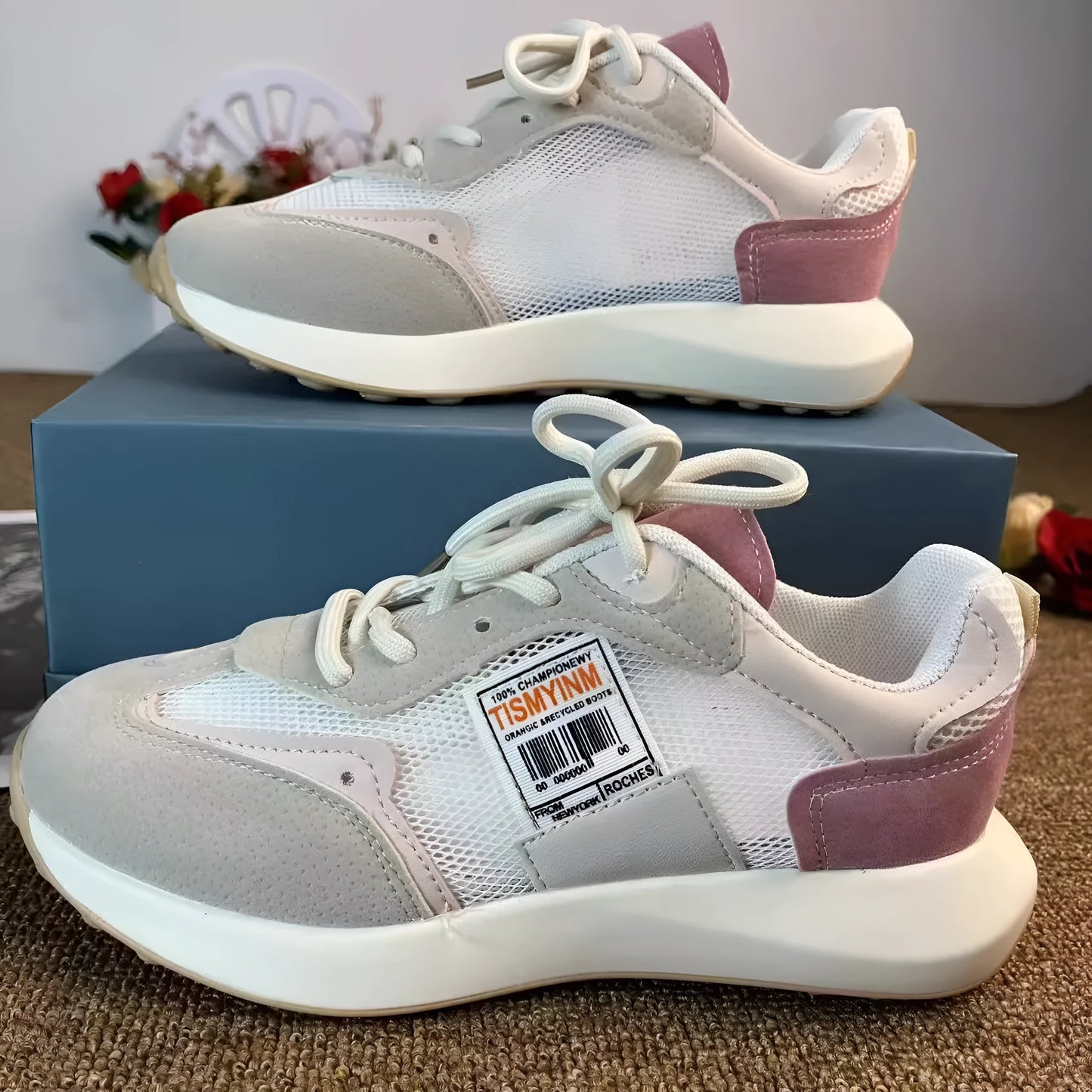 Women's grey low-top retro sneakers with mesh lining and round toe on a flat rubber sole.