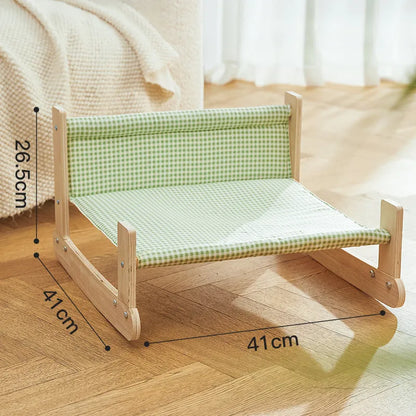 Elevated wooden cat beach chair bed with cloth lounging surface in blue or green.