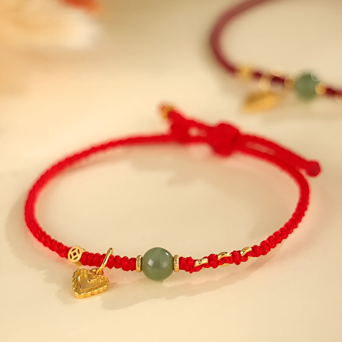Handmade women's bracelet with 925 silver and Hetian jade in woven design with red carrying strap
