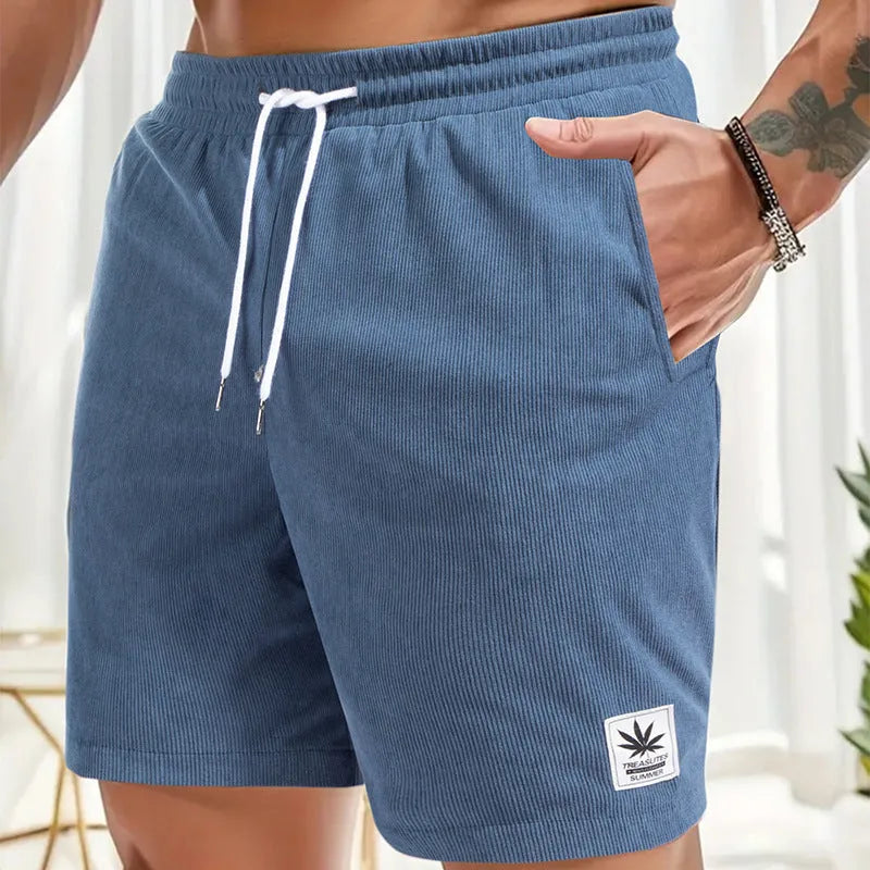 Men's straight-cut drawstring shorts in blue, shown on a model for summer casual wear.