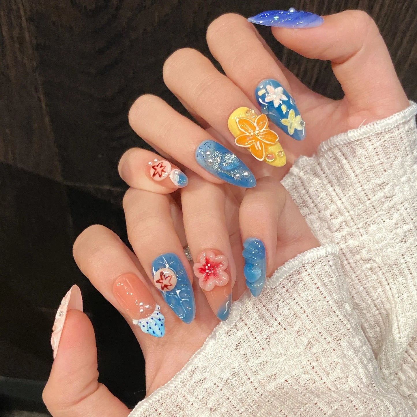 Three-dimensional plastic wearable armour set with carved jellyfish decorations in almond nail colour.