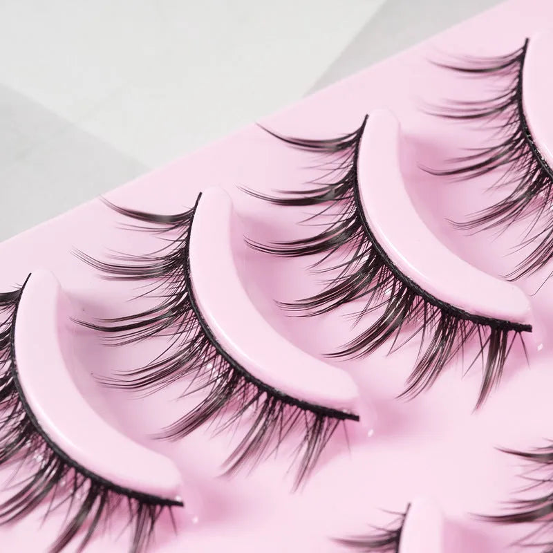 Three styles of black anime false eyelashes on a white background from a 15-pair pack.