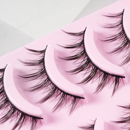 Three styles of black anime false eyelashes on a white background from a 15-pair pack.