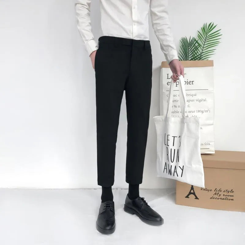 Man wearing black slim straight-leg loose fit cotton trousers with a drawstring waist