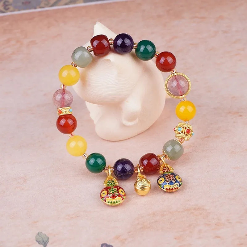 Hand-woven agate bracelet with 10mm beads and a detailed swallowing gold beast charm.