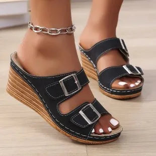 Women's creamy-white outer wedge beach slippers with a belt buckle detail on the strap.