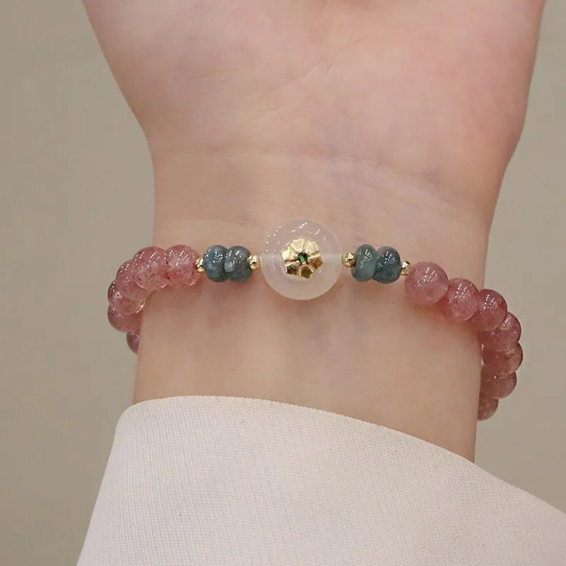 Women's bracelet with strawberry quartz stones and blue water emerald round jade pendant featuring peace buckle closure